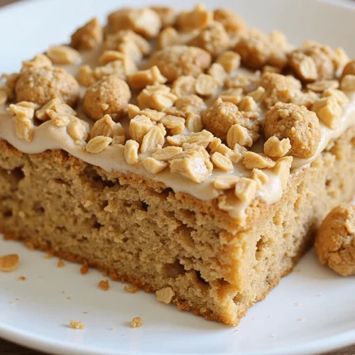 Homemade apple oatmeal cake with caramelized apple topping on a wooden table, with a slice cut out, showing its moist, oat-filled texture.